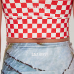Red and white checkered crop top with 'Salt Gypsy' branding, worn by a person.