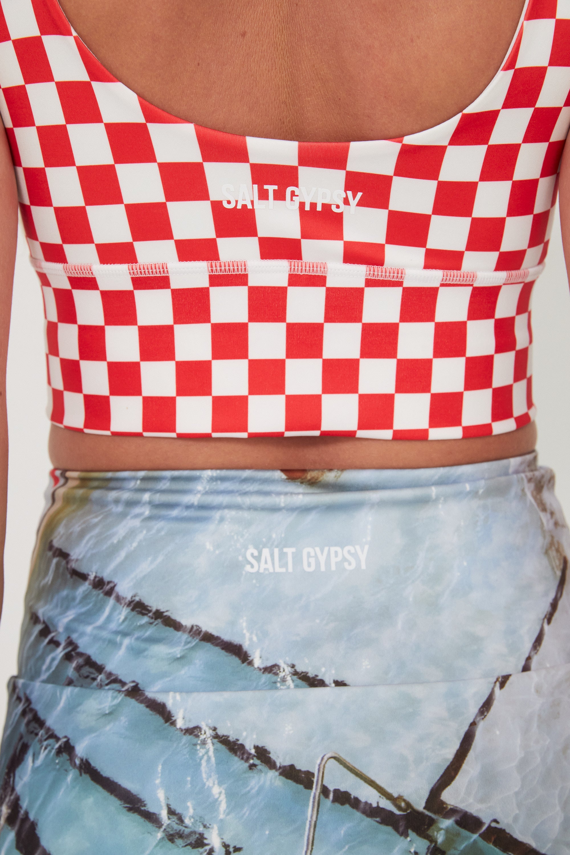 Red and white checkered crop top with 'Salt Gypsy' branding, worn by a person.