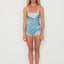 Woman wearing a blue and white patterned, ocean inspired swimwears outfit on a white background