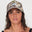women wearing a camouflage dad cap with blue embroidered salt gypsy text on a plain background