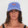 Woman wearing a blue dad cap with a red 'Salt Gypsy' logo on a white background